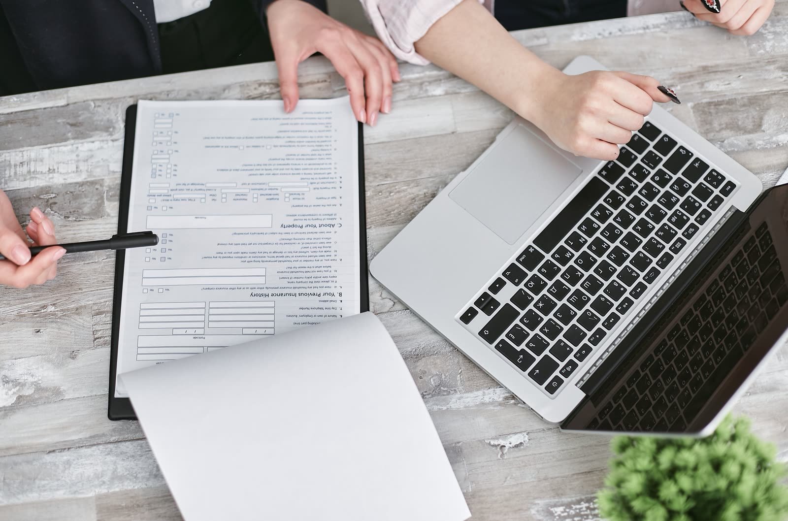 Documents and laptop on a table during a business discussion